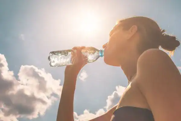 Hydration: The Secret Ingredient for a Toned Stomach and Enhanced Fitness 3 Image of woman drinking water to hydrate Willenhall after run.